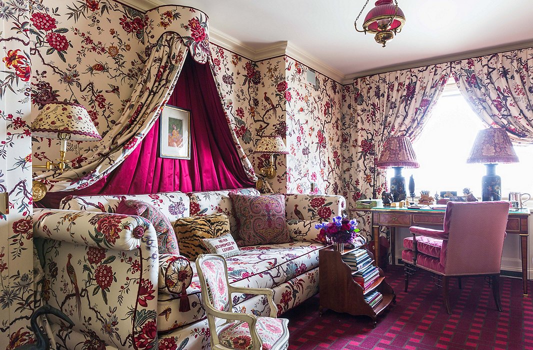 Once a petite bedroom, this space now serves as a dressing room and office for Alex’s partner, Scott. The basket-weave carpet, designed by Alex, adds geometric contrast to the Manuel Canovas floral.
